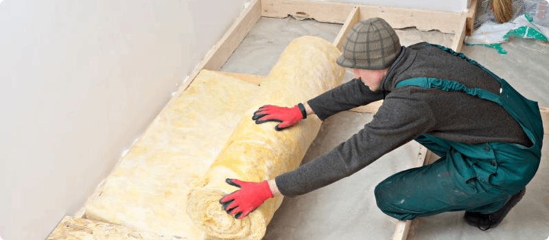 Worker installing insulation. 