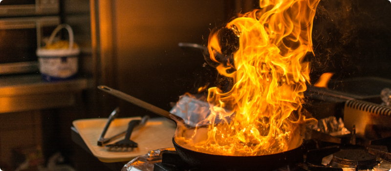 A close-up of an on-fire pan on the stove.