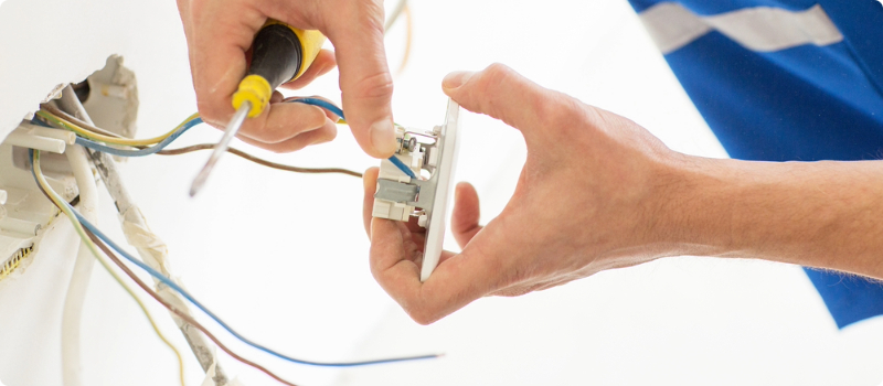 A worker fixing their home's wiring.