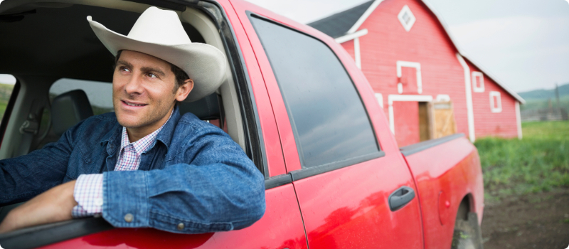 A smiling person in a truck. 