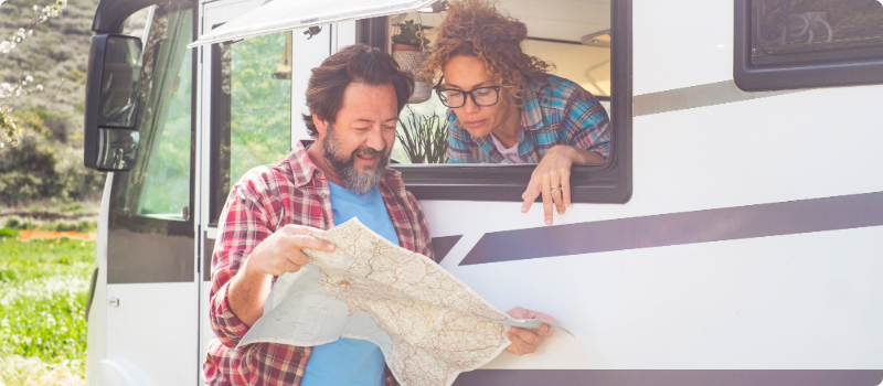 A couple planning their trip with a map.