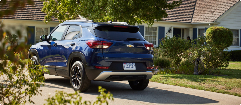 A vehicle idling in a driveway.