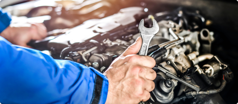 A mechanic working on a car's engine.