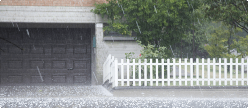 The outside of a house during a hailstorm. 