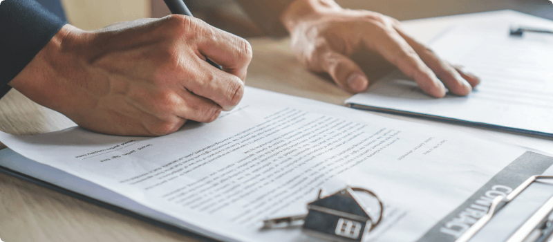 Person signing a home contract.