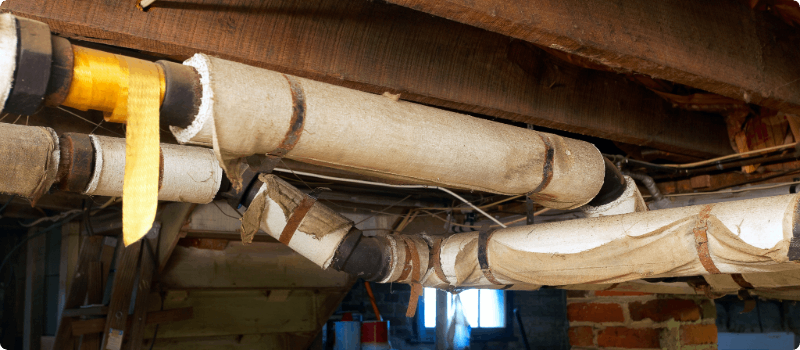 Basement pipes wrapped with insulation.
