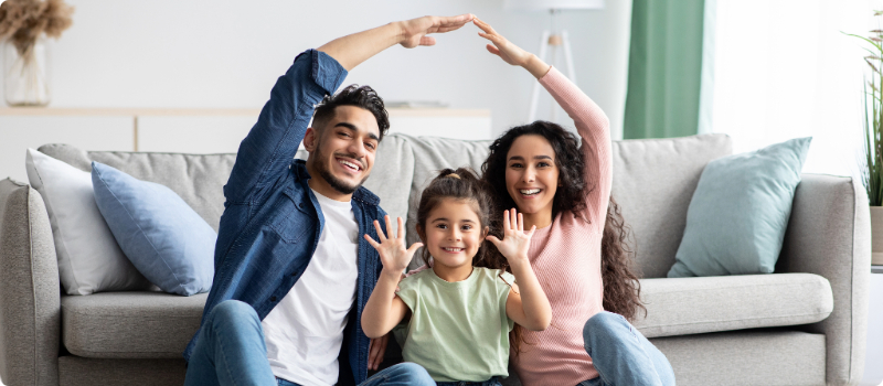 A happy family sitting together in their living room.