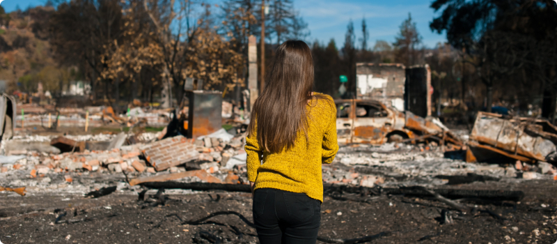 A homeowner looking at their home's ruins after a tornado.