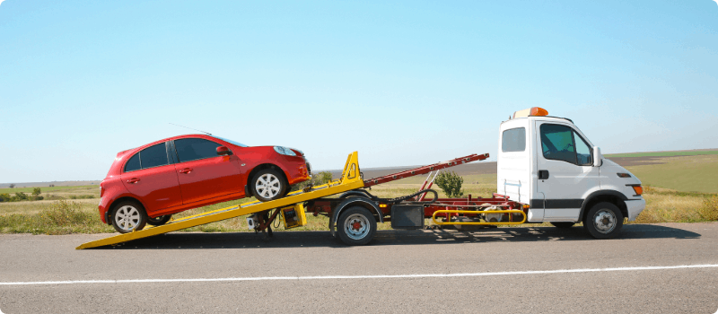 Car being loaded onto a tow truck.