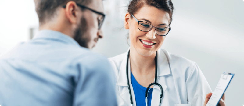 A doctor reviewing a document with a patient.