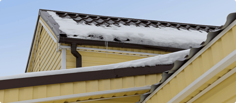 Snow and ice on a roof and gutters. 