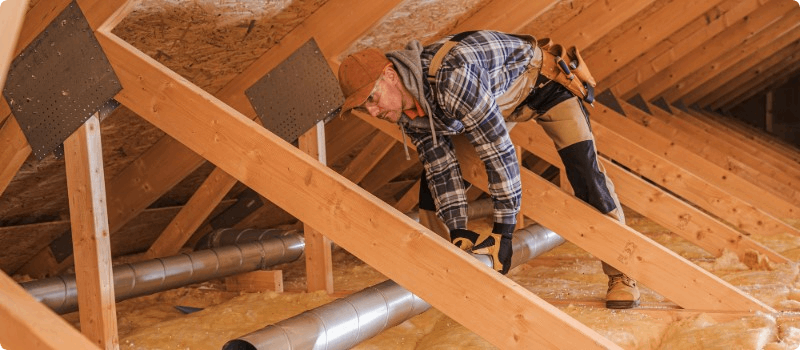 Worker insulating an attic. 