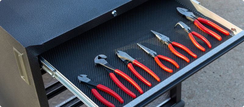 A tool drawer full of pliers.