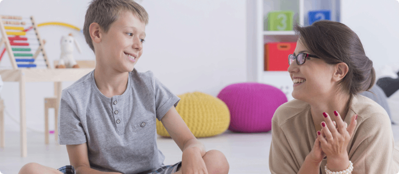 A volunteer tutor speaking to a student.