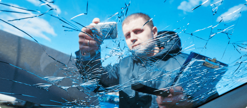 Insurance adjuster taking images of windshield damages.