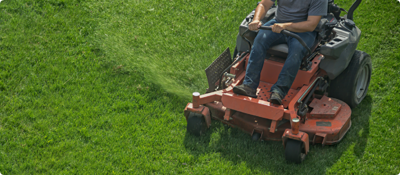 riding lawnmower cutting grass