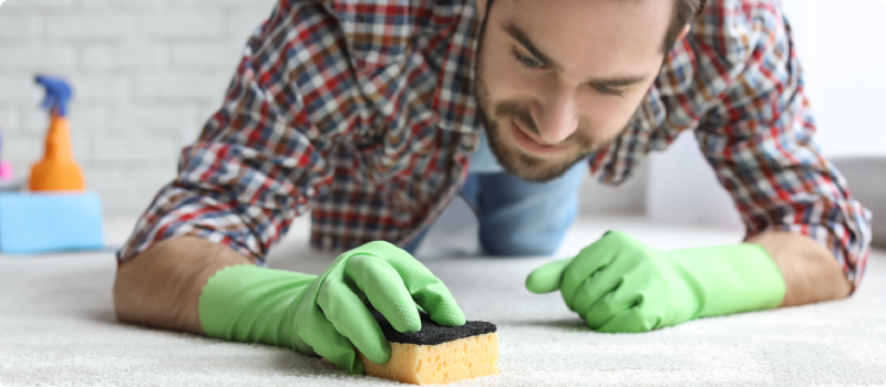 man scrubbing a floor