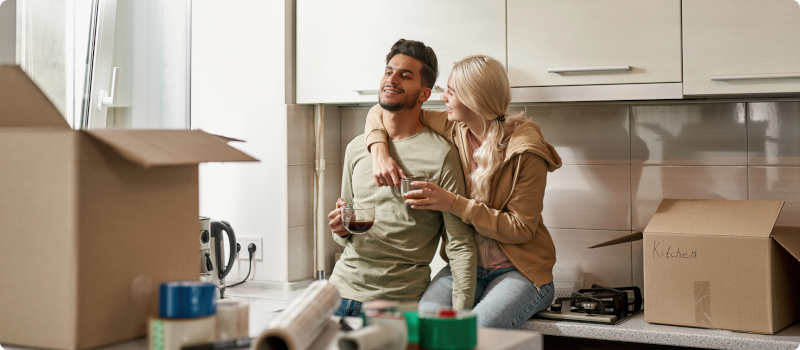a man and woman in their apartment kitchen