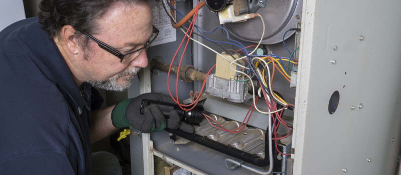 Technician working on a gas furnace.