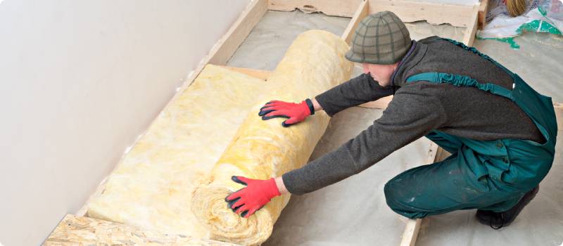 a man installing attic insulation