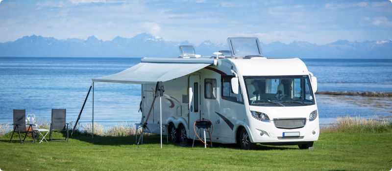 a recreational vehicle parked near a lake