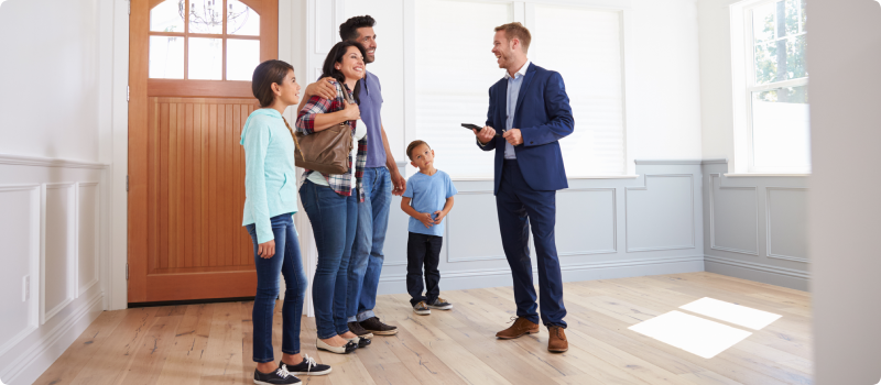 Realtor Showing Hispanic Family Around New Home