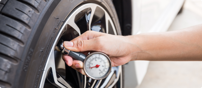 Picture of a person checking tire pressure