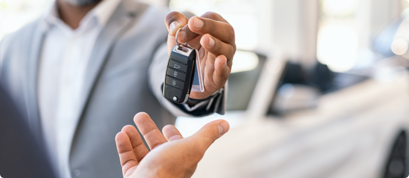 A man handing car keys