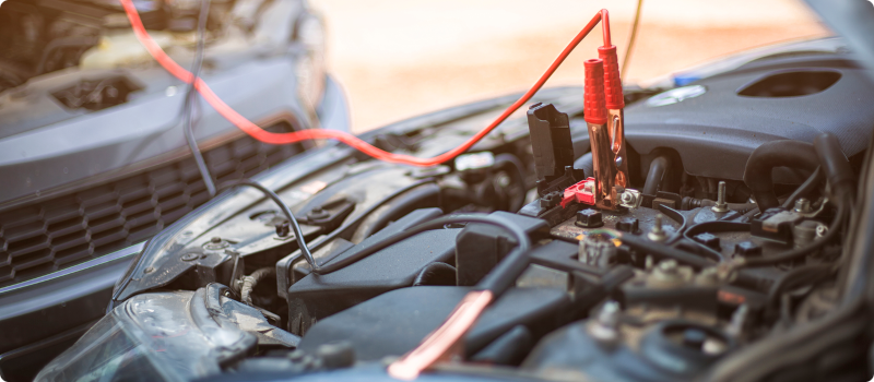 jumper cables on a car battery