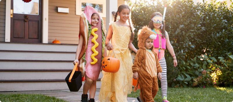 a group of children in costumes trick or treating