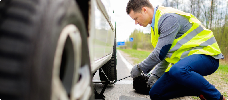 roadside assistance replacing a flat tire