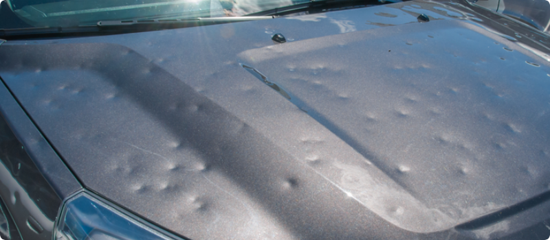 hail damage on the hood of a car
