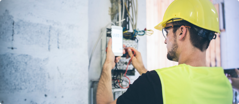 An electrician fixing up the wires and measuring volts