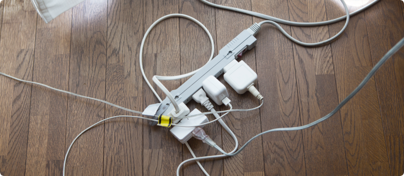 Electrical cords connected to a single extension block.