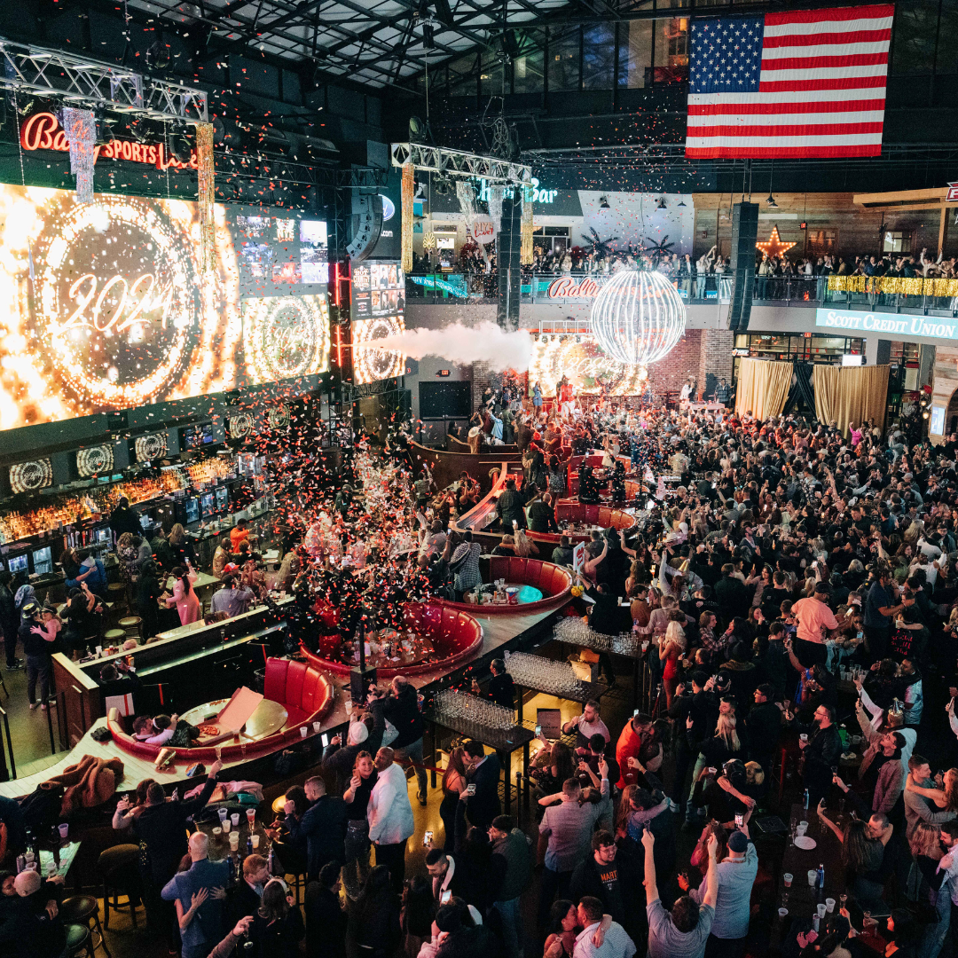 Ball drop and confetti celebration at New Year's Eve party in Ballpark Village