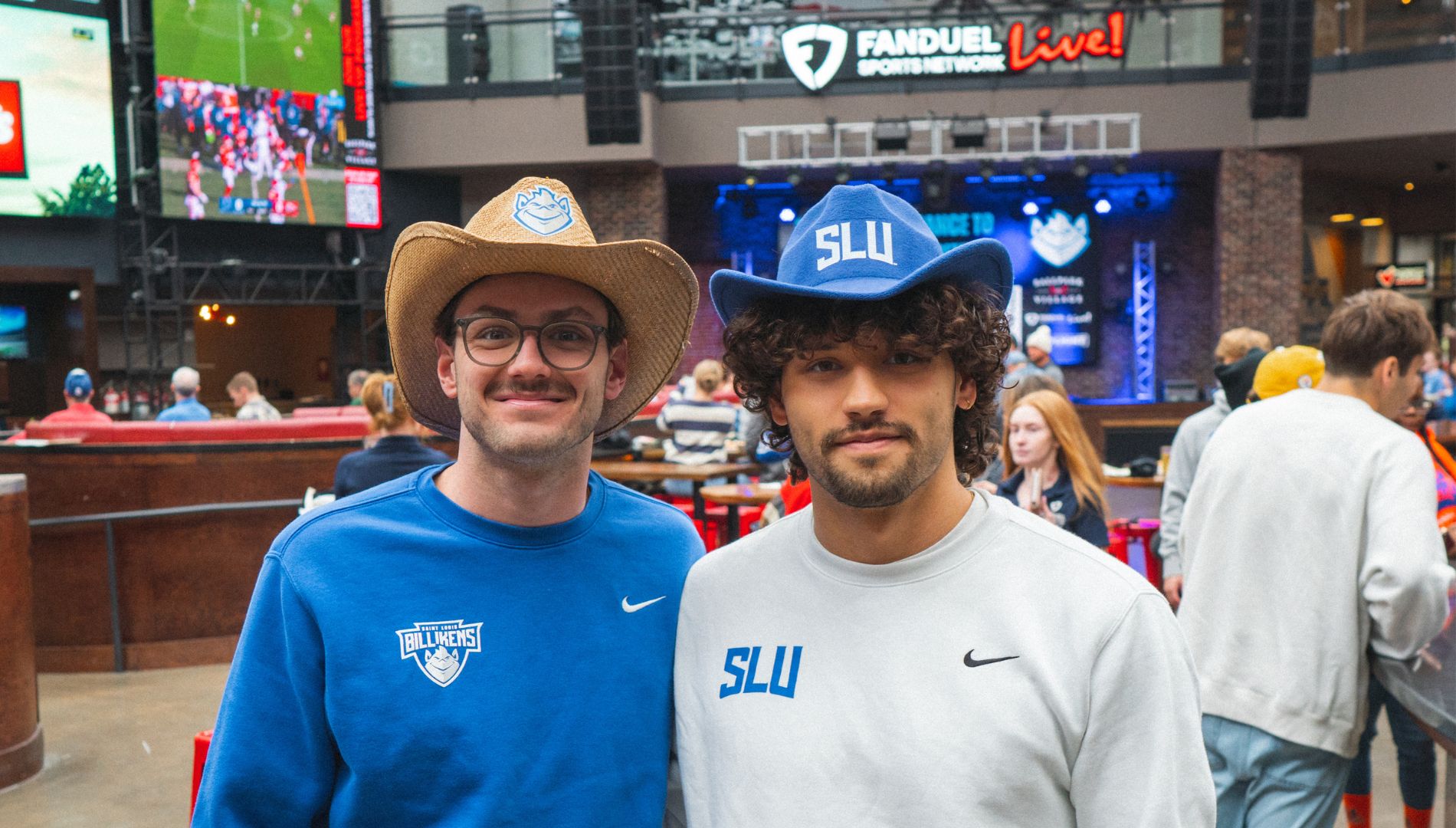 Two college kids with hats