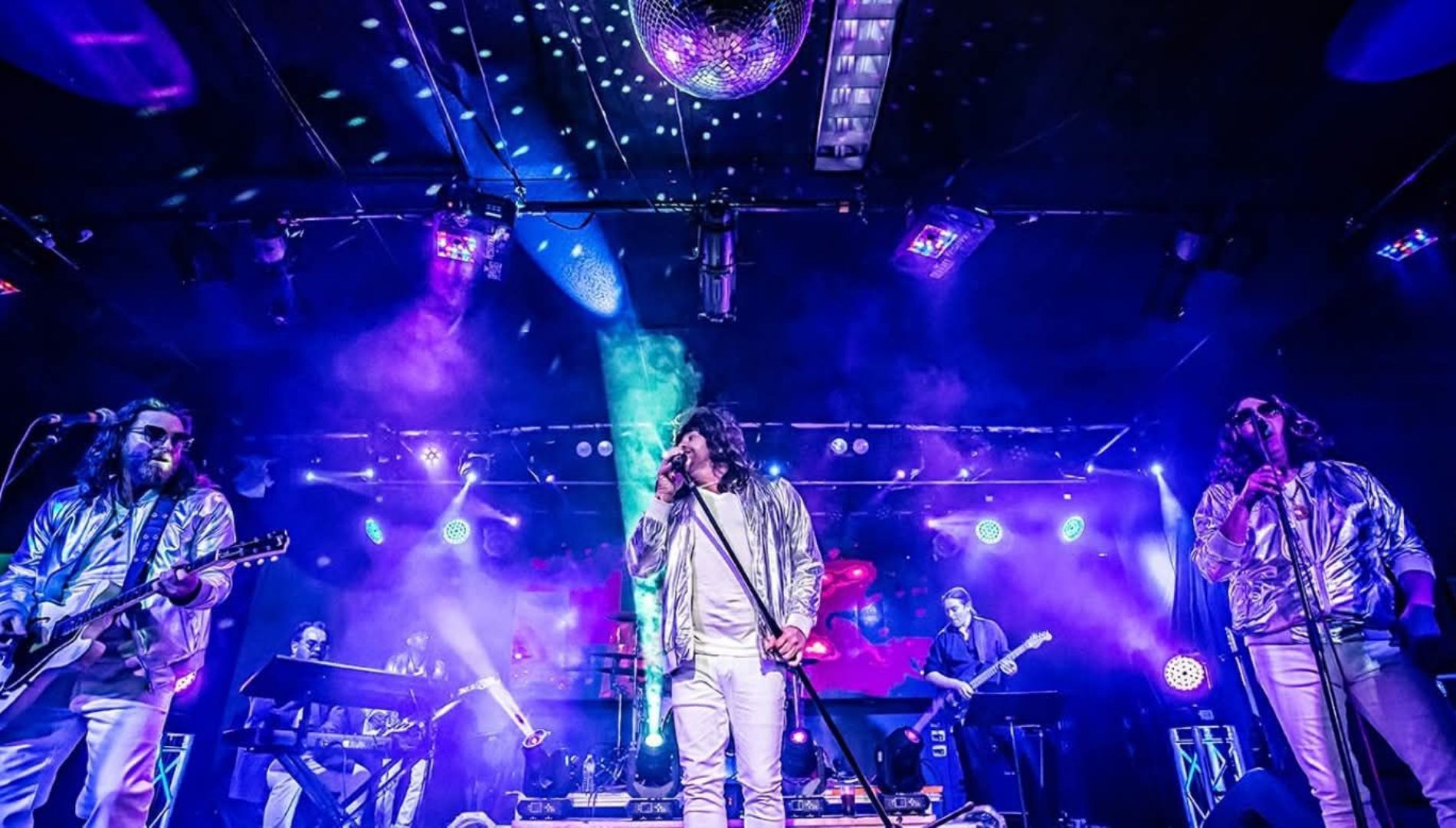 Artist singing in stage with his band