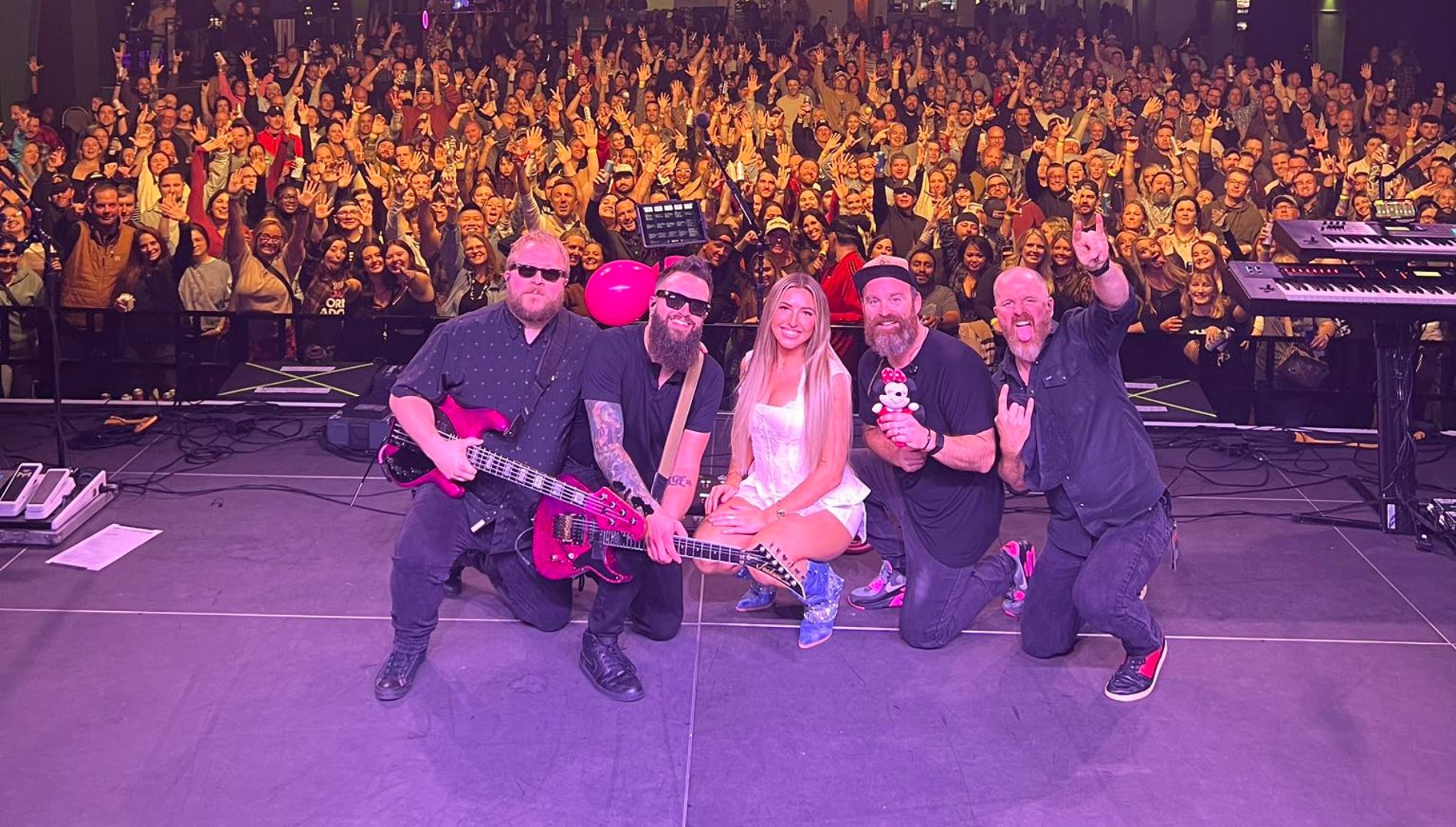 Music band on stage with crowd in the background