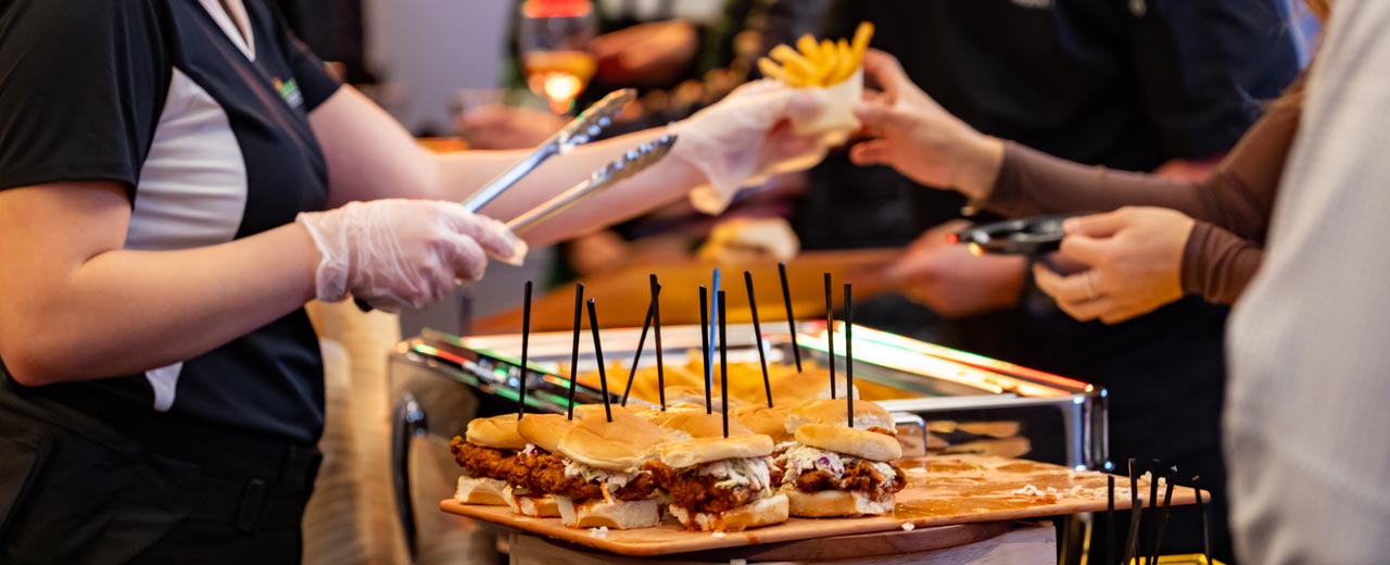 Staff serving food to guest at buffet