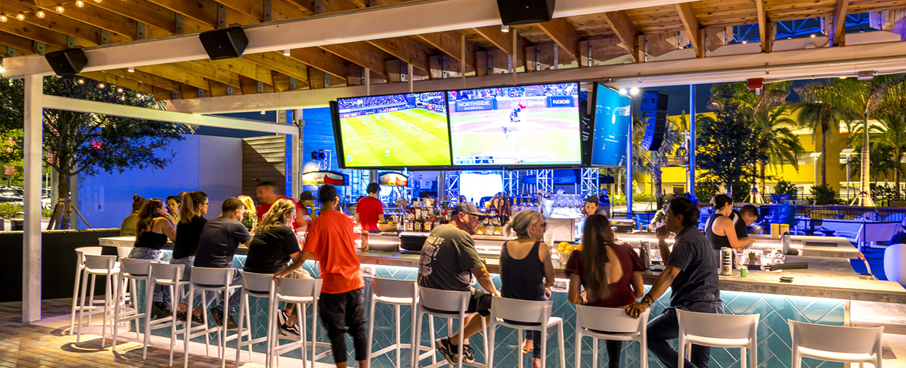 Image of some guests seated at the bar in Vivo! Plaza.