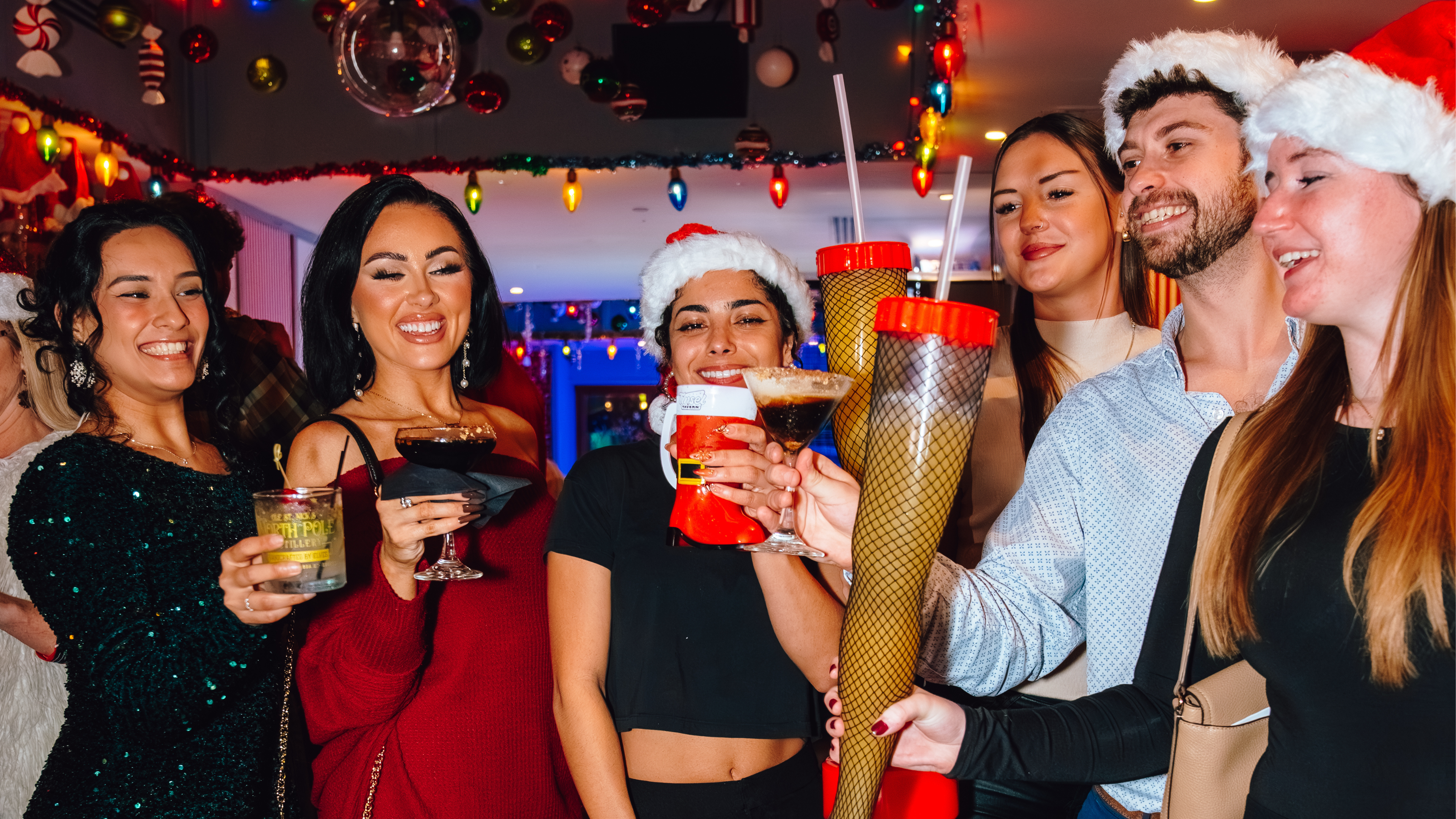 An image of people cheering their drinks at Tinsel Tavern.