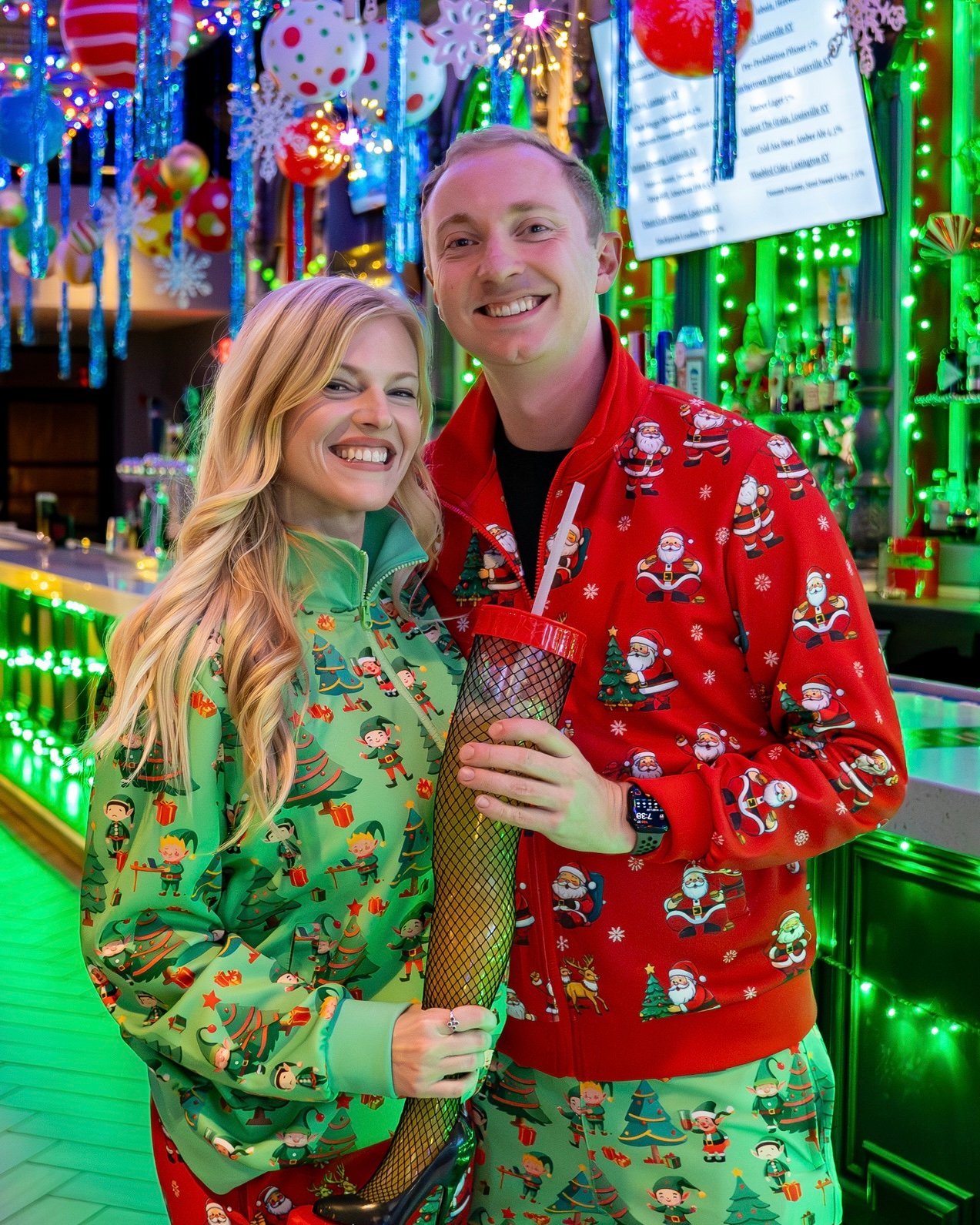 An image of a couple in holiday pj's at Tinsel Tavern.