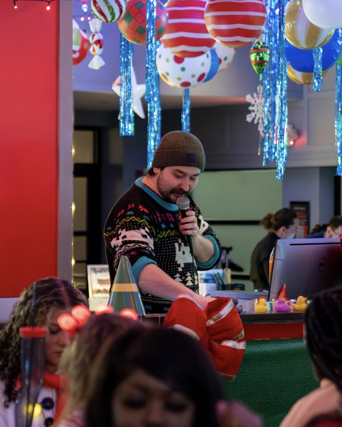 A DJ speaking into the mic at Tinsel Tavern.