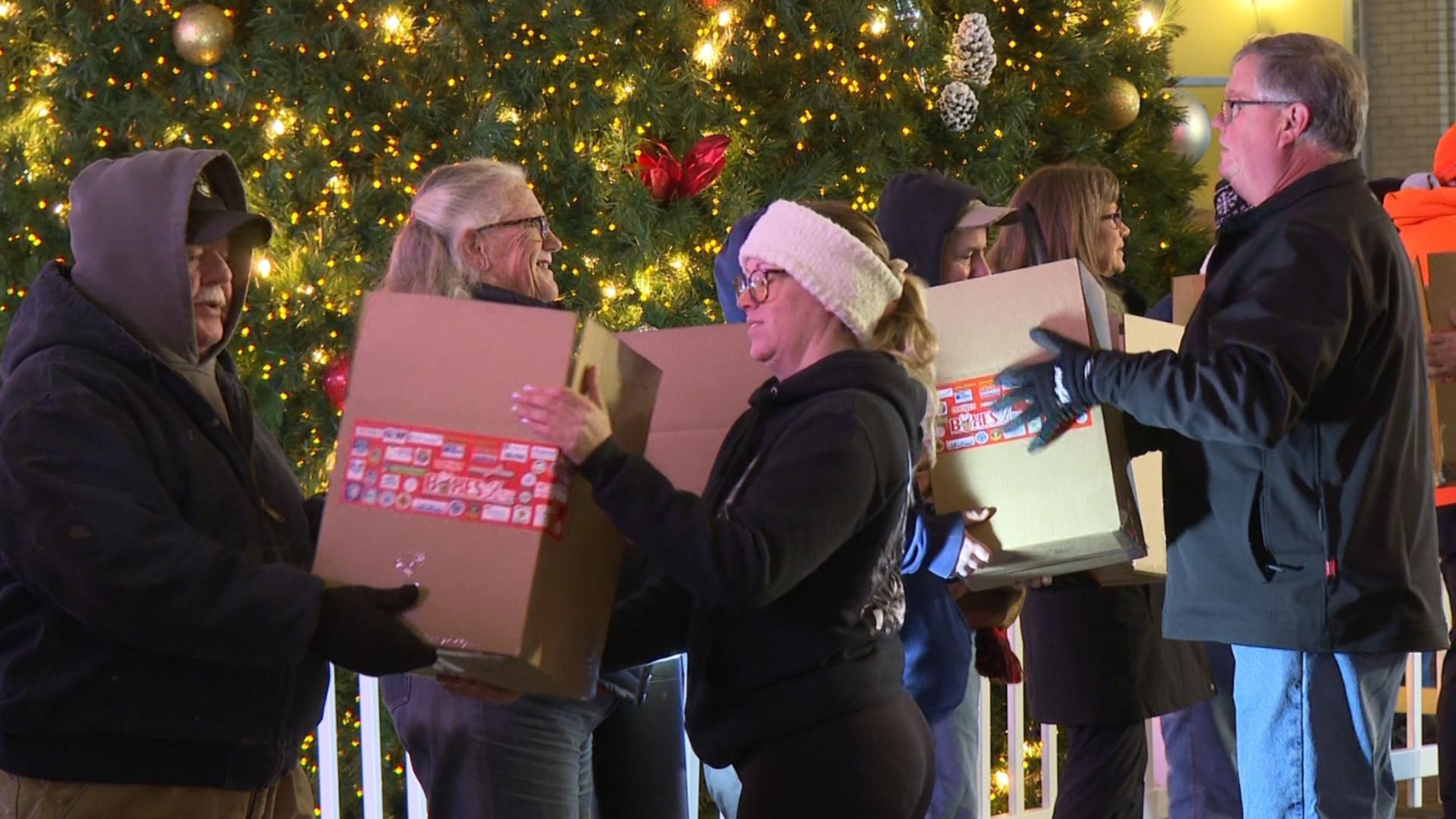 Volunteers passing boxes at Boxes of Love.