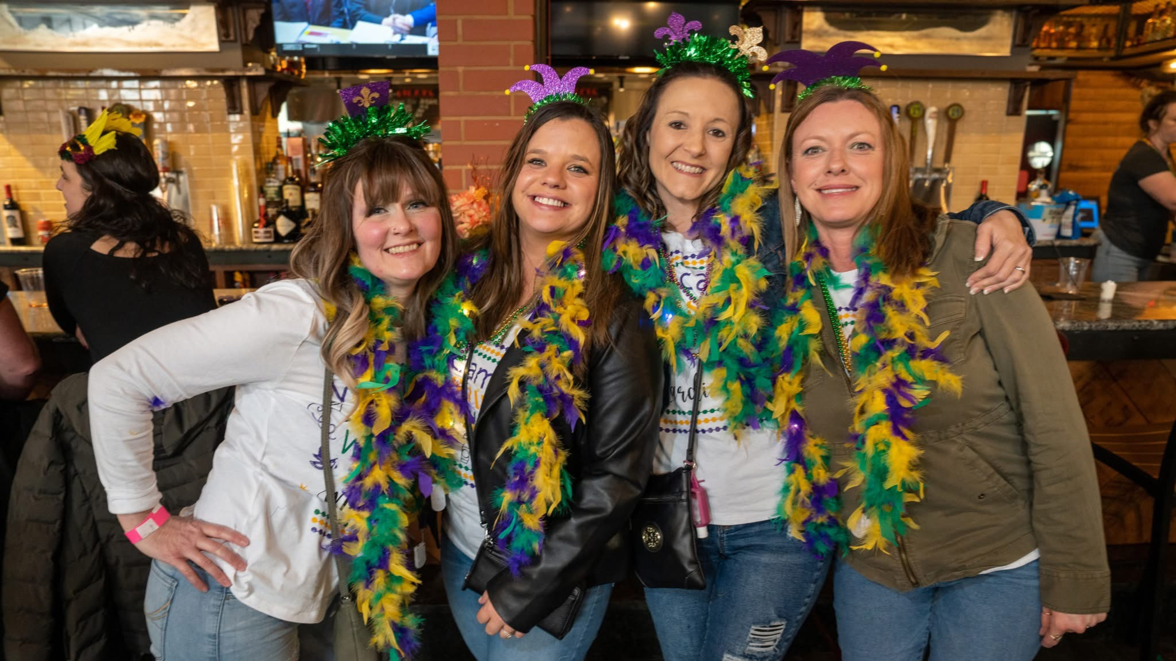 Woman wearing Mardi Gras boas.