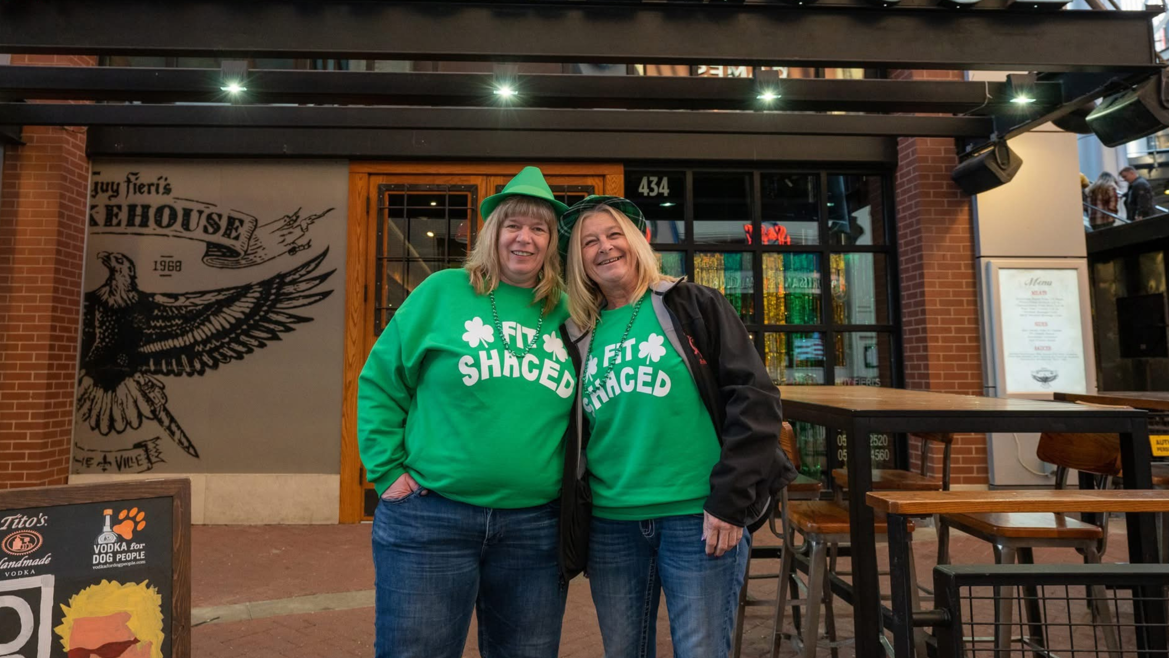 An image of two women in green outfits.