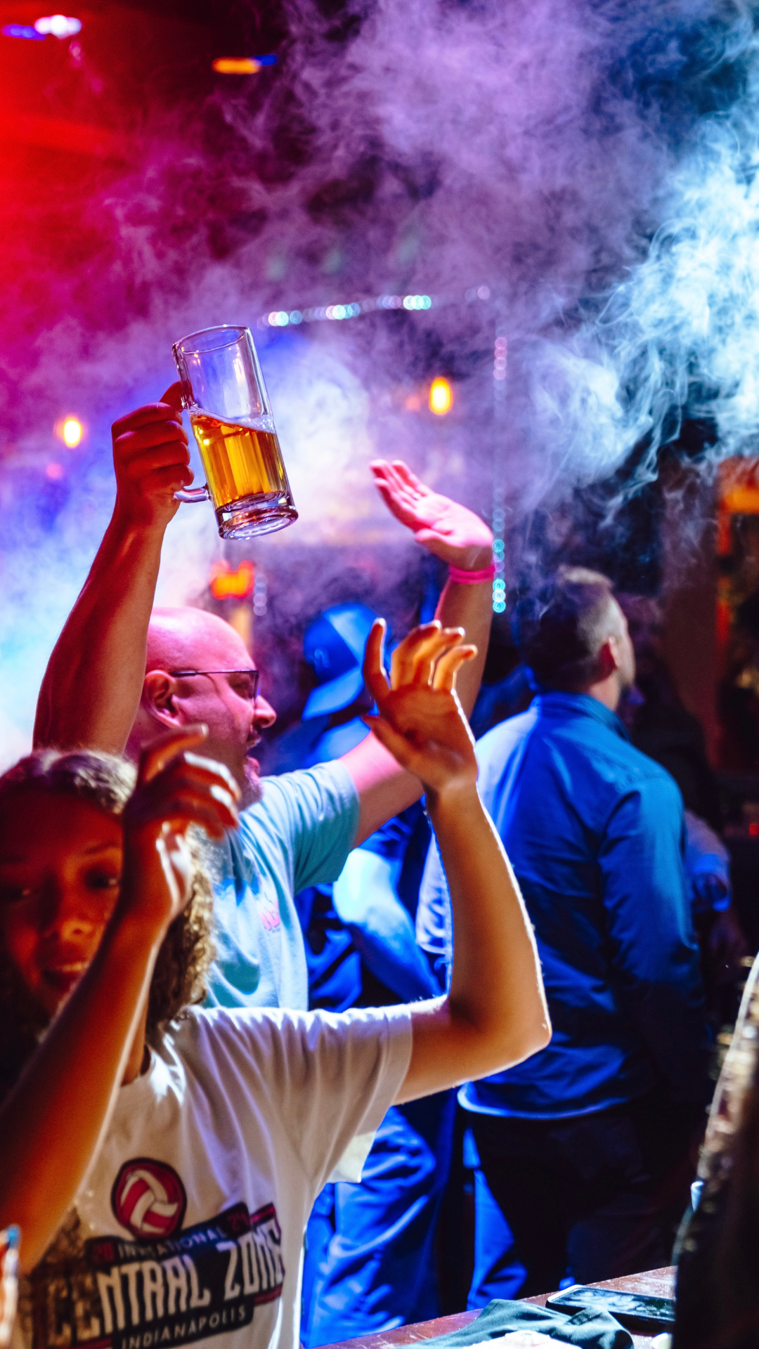 An image of people cheering as the co2 cannons go off.