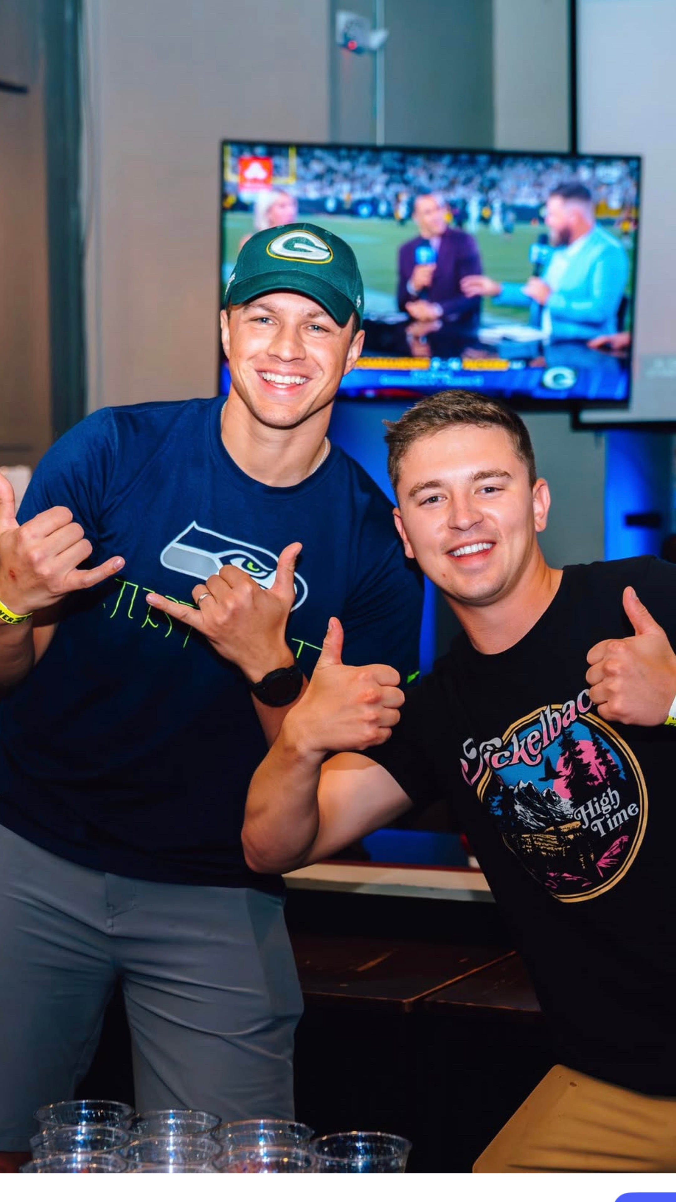 Two men giving a thumbs up.