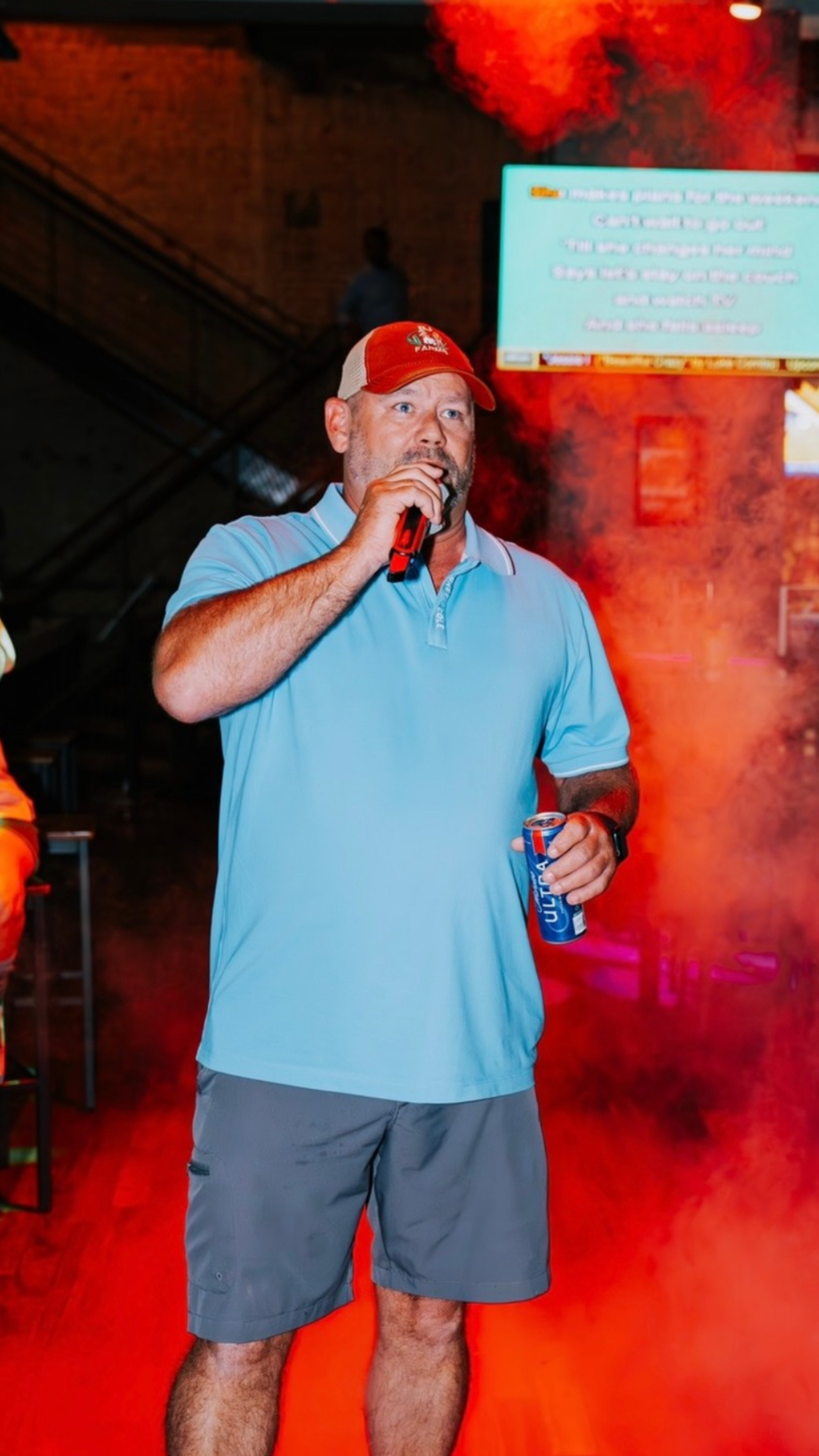 An image of a man singing karaoke at Sports and Social.