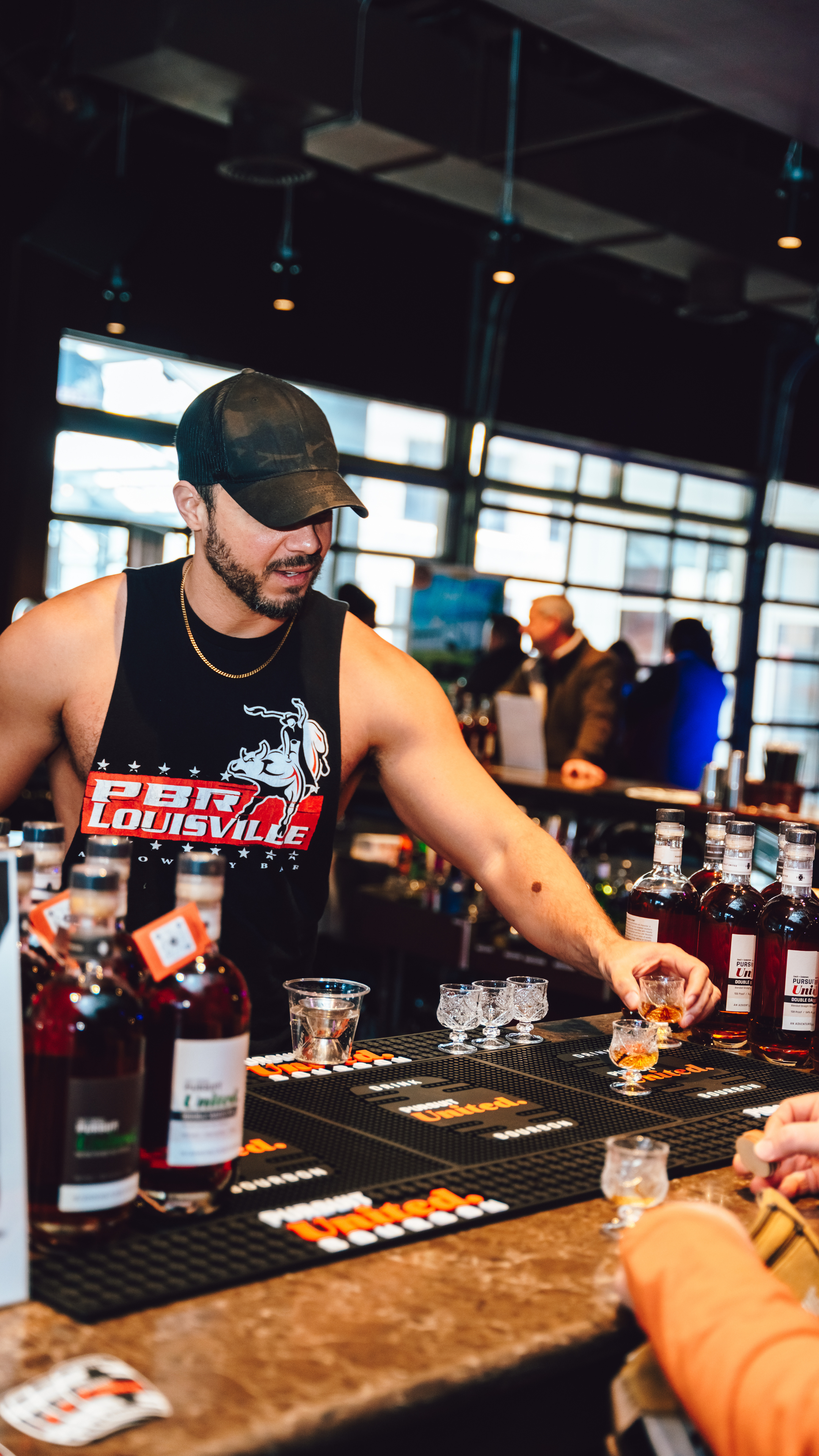 An image of a PBR Louisville bartender handing out bourbon at Pig and Swig.